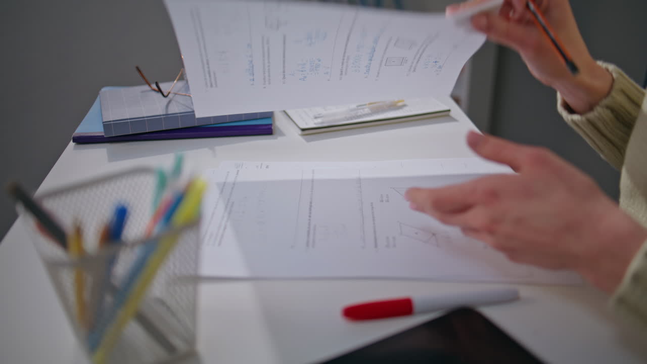 Unknown teacher checking homework at office desk closeup. Woman putting marks