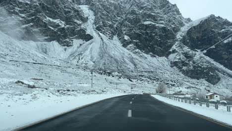 a car driving on skardu highway during snowfall, pakistan