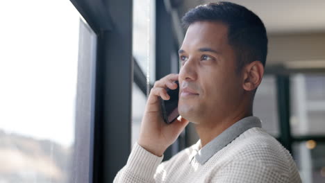 Business-man,-phone-call-and-talking-by-window