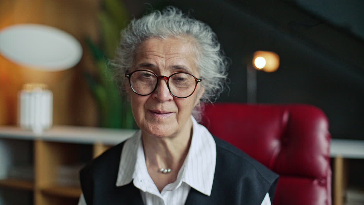Portrait of Elderly Female Therapist during Counseling Session in Modern Office