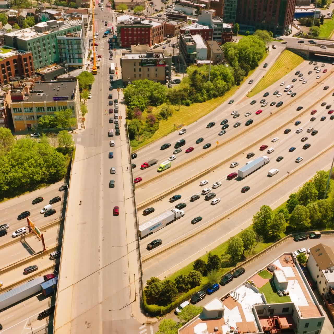 Chicago wide-lane road crossed by another one from above. Busy traffic of the urban city at the backdrop of residential area
