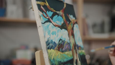 artist painting a tree in the studio