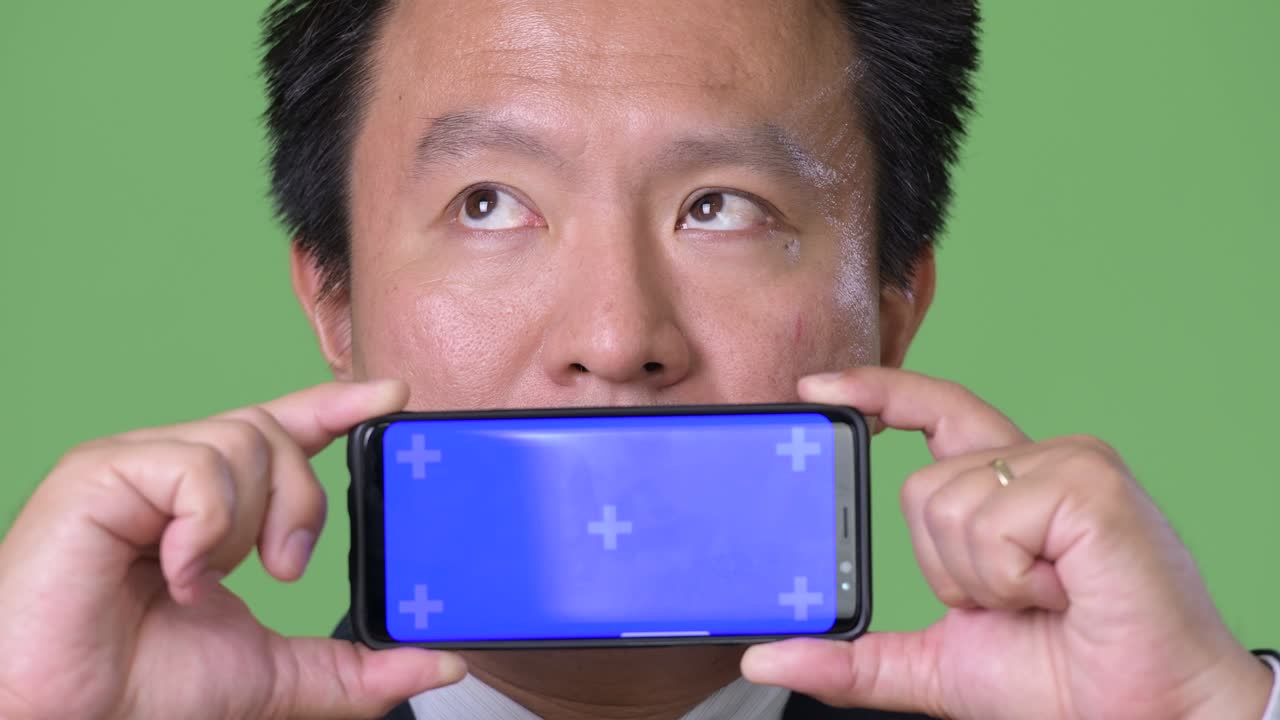 녹색 배경에 성숙한 일본 사업가