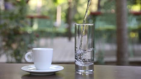 filling water in the glass at the cafe