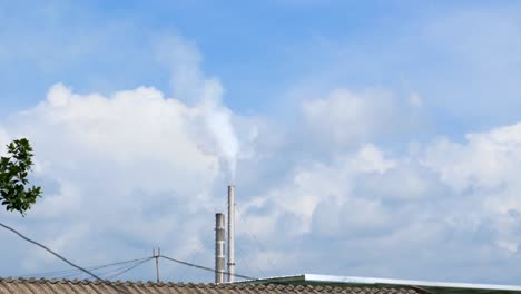 white smoke from the chimney of the factory