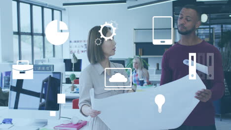 animation of multiple icons over diverse architects discussing floor plan on blueprint in office