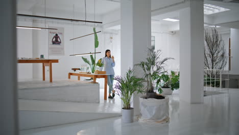 morning woman drinking water in design store. successful businesswoman owner