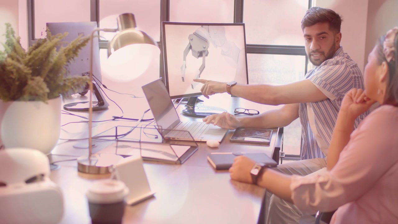 Male engineer pointing at monitor and rotating 3D prosthetic model using laptop, reviewing design