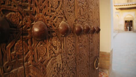old wooden gates to madrasah mohammed rahim khan. khiva uzbekistan fortress ichan kala 5