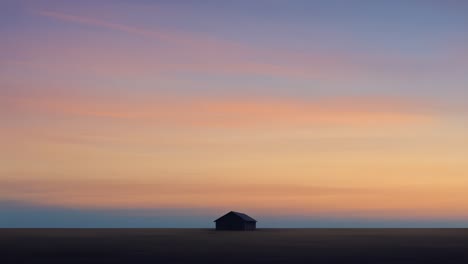 a serene sunset over a lonely house in the field: capturing the tranquil beauty of nature's evening palette