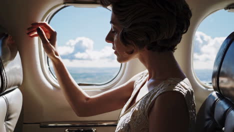 woman looking through airplane window