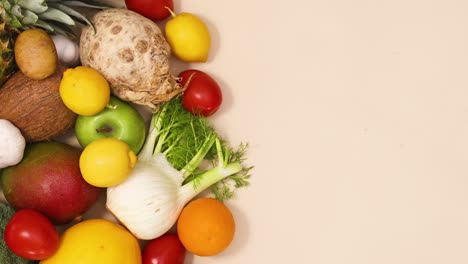 healthy composition of fresh and ripe fruits and vegetables on the left side of the table with copy space. stop motion flat lay