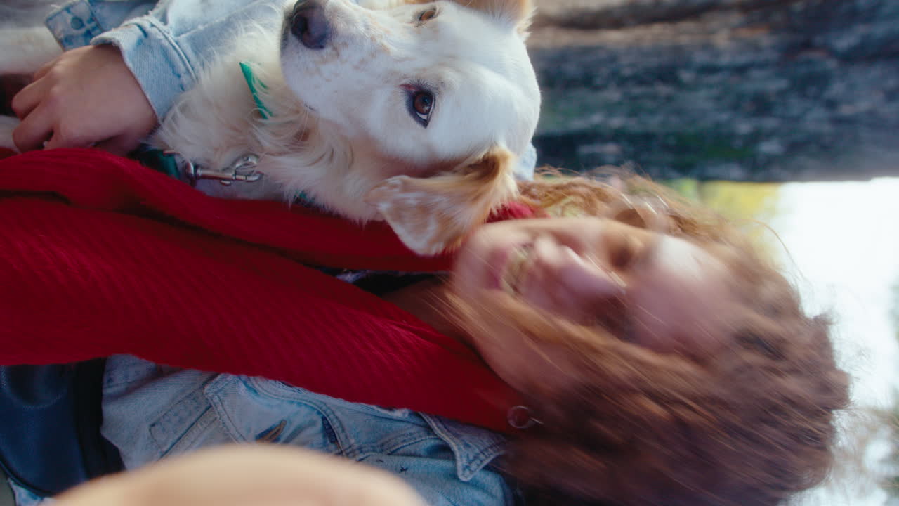 Happy Woman Hugging and Kissing Dog during Video Call