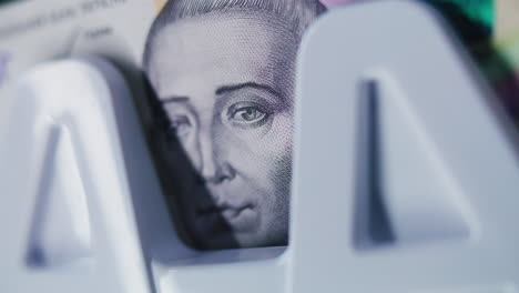 close-up of a banknote with a historical figure