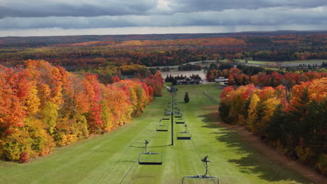 Empty-Ski-Lift-Chairs-Over-Green-Slope-With-Autumnal-Trees-At-Mount-St-Louise-Moonstone