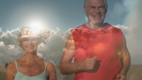 animation of glowing light over smiling senior couple running by seaside