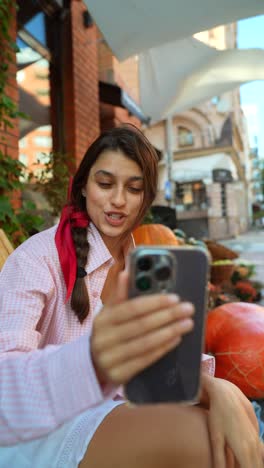 young woman on video call outdoors