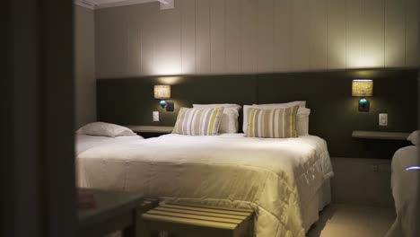 modern hotel room featuring a cozy double bed, ambient lighting, and stylish decor, creating a welcoming and relaxing atmosphere for guests