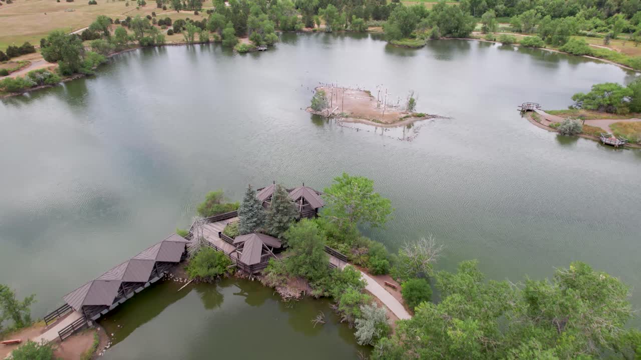 Aerial view of a lake with an island and a bridge