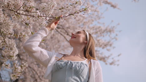 Happy-Portrait-Of-A-Young-Woman-In-Yangjae-Citizen's-Forest-Park-With-Blooming-Sakura-Flowers-In-Seocho-District,-Seoul-City,-South-Korea