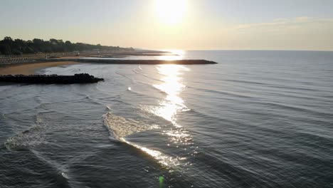 Fly-over-over-the-ocean-in-golden-hour-in-Caorle,-coast-city-in-north-Italy