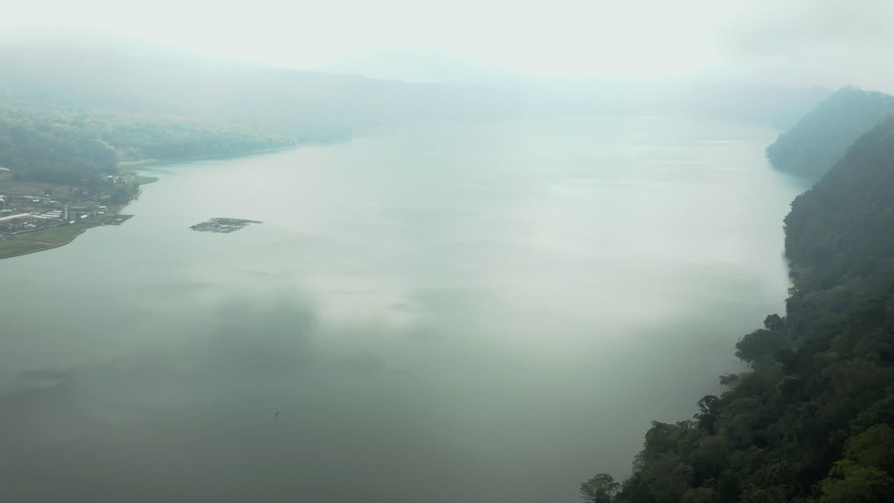 Aerial Video; A drone flies over a lake shrowded in mist