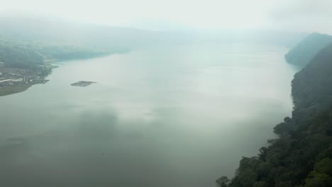 aerial video; a drone flies over a lake shrowded in mist