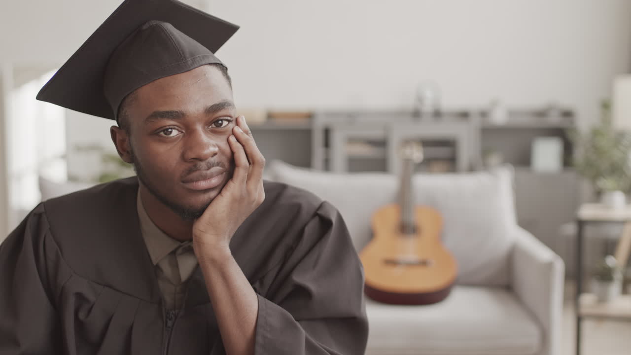 Portrait of African Graduate Wearing Graduation Gown and Cap