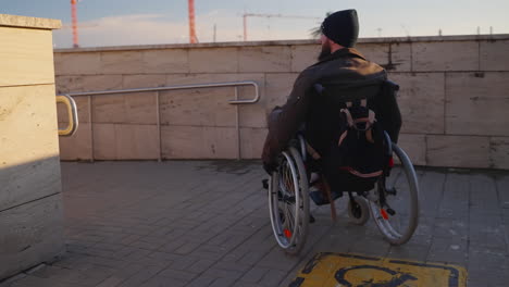 person in wheelchair on accessible ramp