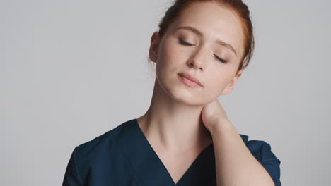 Redheaded-doctor-in-front-of-camera-on-gray-background.