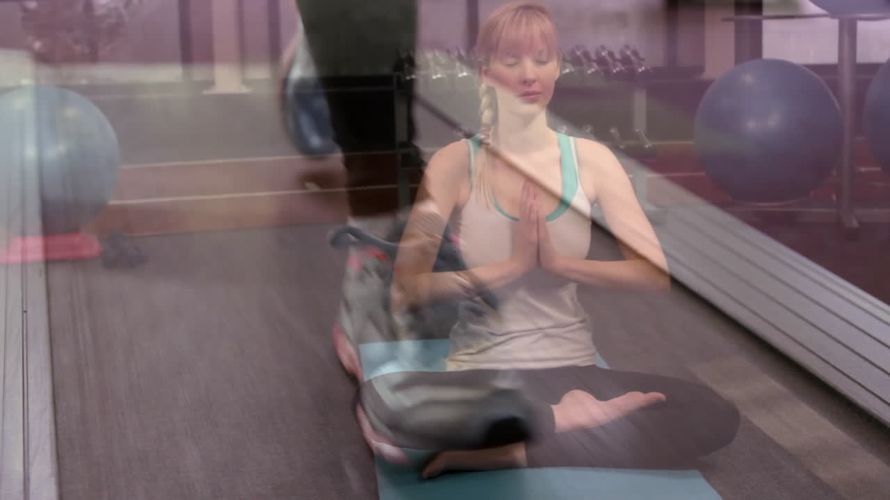 Woman meditating on yoga mat in fitness studio showing treadmill motion with animated fitness icons