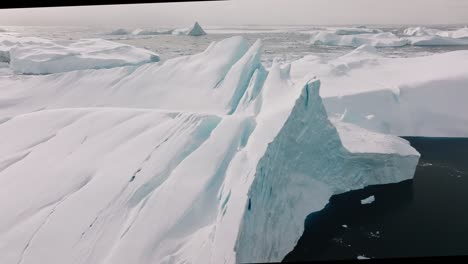 drone over sea and ice of ilulissat icefjord