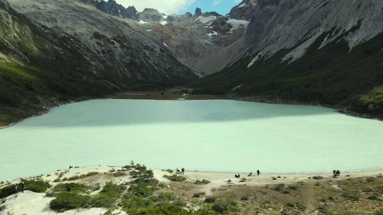 Aerial view emerald lagoon with people on the coast