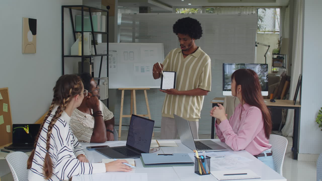 Black UX Designer Presenting App Interface to Team