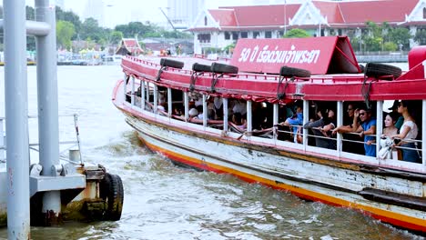 passenger boat approaches dock on bangkok river