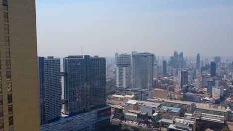 phnom penh city under hazy sky, smog due to air pollution and climate change, drone shot