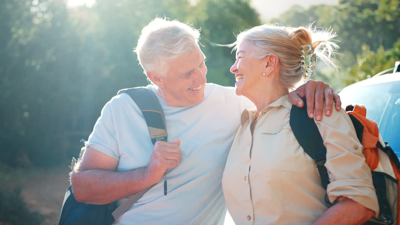retrato de una pareja mayor que va de excursión en el campo de pie por el coche juntos