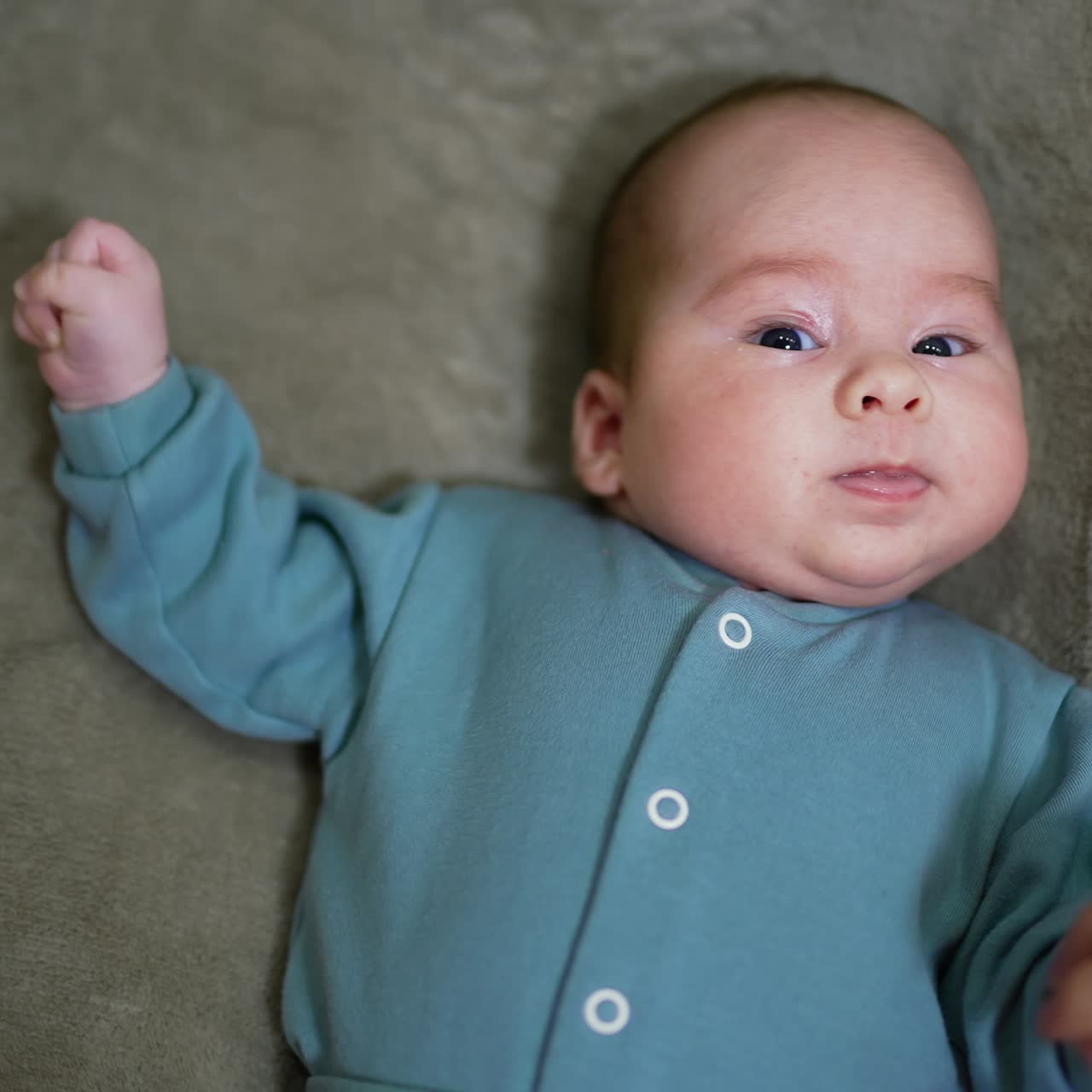 Baby laying on the back. Small cute kid lyiing on the bed