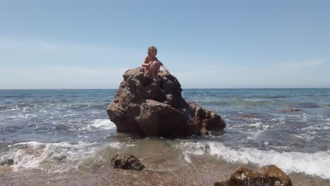 Ein-Mädchen-Auf-Einem-Riesigen-Felsen-In-Playa-De-Cabo-De-Gata-Im-Sommer-In-Spanien