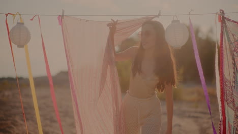 beautiful young woman standing by sarong at beach