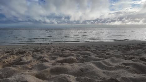 a peaceful beach scene with soft sand and the ocean waves rolling in, captured in hyperlapse