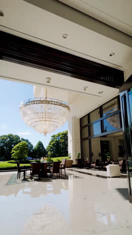 luxury house outdoor dining area with large chandelier