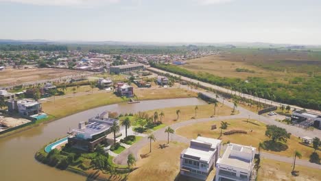 high-end horizontal residential houses built at the beautiful ponta da figueira peninsula in brazil with navigable canals - aerial shot