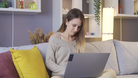 young woman working with laptop at home.