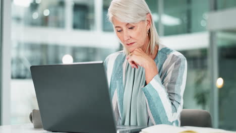 senior woman working on laptop in office
