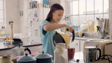 pretty hispanic girl making hot drink wearing pyjamas at home