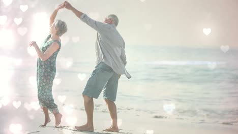 Fröhliche-ältere-Menschen-Im-Ruhestand-Tanzen-Am-Strand-Mit-Herzanimation-Zum-Valentinstag