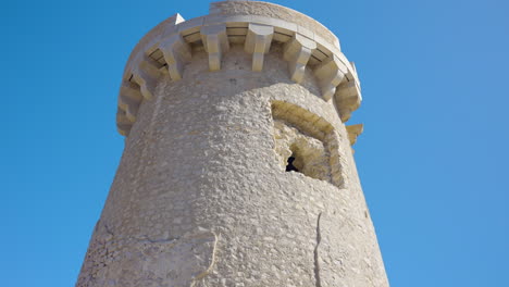 damaged stone tower with missing window