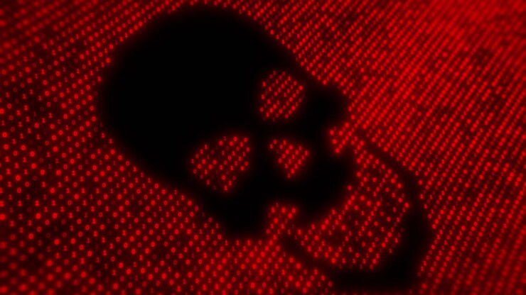 Computer virus code on a screen with a skull malware attack trojan attack digital theft identity