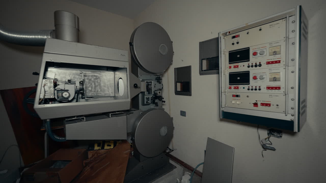 Old Film Projector and Control Panel in Abandoned Cinema Projection Room